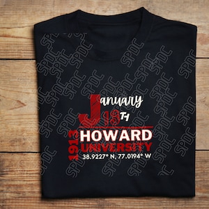 May include: Black t-shirt with a red graphic design that says "January 19th 1913 HOWARD UNIVERSITY 38.9227° N, 77.0194° W"