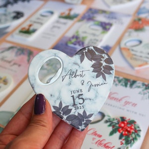 May include: White marble heart-shaped bottle opener with a black floral design and the text "Albert & Jessica" and "June 15, 2025".