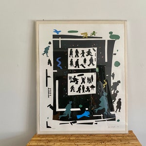 May include: A black and white print of a city scene with people walking and a blue bird flying overhead. The print is framed in a white frame.