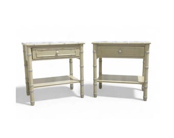 May include: Two white painted nightstands with a bamboo design. Each nightstand has a single drawer and a lower shelf.