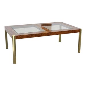 May include: Rectangular coffee table with a burled wood top and two glass inserts. The table has brass-colored metal legs and trim. The table is approximately 48 inches long, 24 inches wide, and 16 inches high.