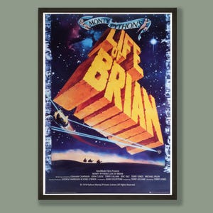May include: A framed film poster for Monty Python's Life of Brian featuring large, three-dimensional yellow block letters against a dark blue starry space background. The border contains small black and white portraits of various characters.