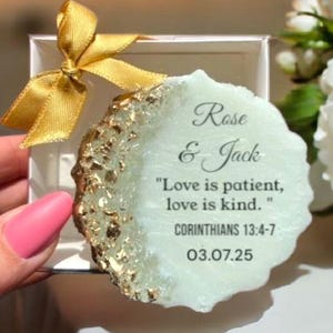 May include: A white and gold agate coaster with the text "Rose & Jack" and the quote "Love is patient, love is kind." from Corinthians 13:4-7. The date 03.07.25 is also included.