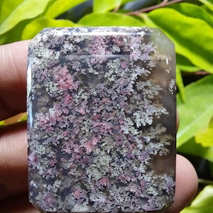 May include: A rectangular polished gemstone cabochon featuring a translucent gray base with intricate, branching dendrite inclusions in shades of deep pink, magenta, and muted green, creating a natural, moss-like pattern throughout the stone.