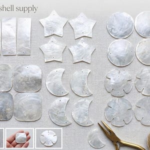 May include: A collection of iridescent white capiz shell supply pieces in various shapes including rectangles, stars, circles, moons, and flower-like forms, each with small pre-drilled holes. Includes metal pliers and a spool of twine.