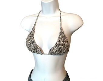May include: A black and white crocheted bikini top with a triangle shape.