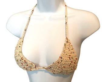 May include: A crocheted bikini top with a cream base and multi-colored flecks of brown, green, and orange.