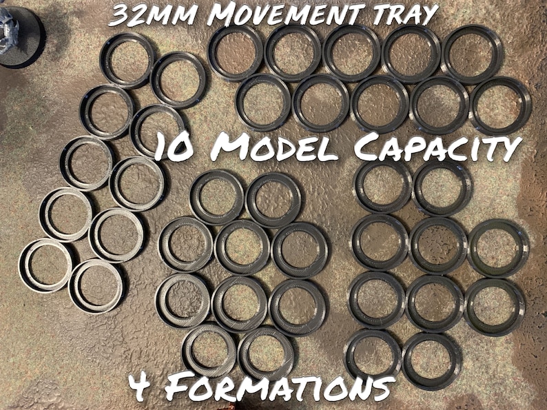 May include: A black plastic movement tray for miniature figures. The tray has 10 circular spaces for 32mm bases and can be used in 4 different formations. The tray is labelled "32MM MOVEMENT TRAY", "10 MODEL CAPACITY", and "4 FORMATIONS".