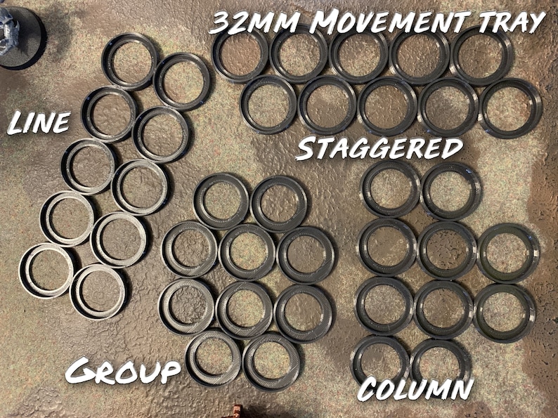 May include: A set of 32mm movement trays for tabletop games. The trays are arranged in four different patterns: line, staggered, group, and column. The trays are black and made of plastic.