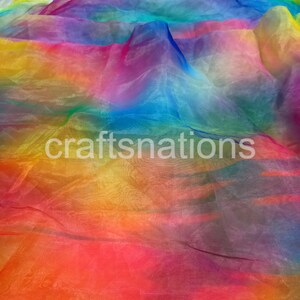 May include: A vibrant, rainbow-colored fabric with a translucent quality. The colors blend seamlessly, transitioning from red to orange, yellow, green, blue, and purple. The text "craftsnations" is visible in the lower left corner.