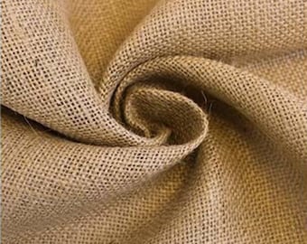 May include: Close-up of a natural brown burlap fabric with a rough texture. The fabric is woven with a tight, even weave and has a slightly rough feel.