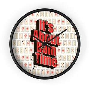 May include: A round wall clock with a black frame. The clock face features a pattern of Mahjong tiles and the text "It's About Bam Time" in red and black.