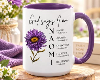 May include: A white ceramic mug with a purple interior and handle. The front features a purple flower illustration and the text God says I am NAOMI with the words Noble, Adored, Overcomer, Made New, and Illuminated, each with a Bible verse reference.
