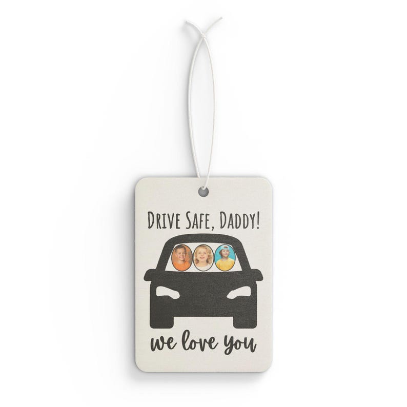 May include: Rectangular air freshener with a white background and a black car graphic. The text "DRIVE SAFE, DADDY!" and "we love you" are printed above and below the car. Inside the car are three circular photos of children.