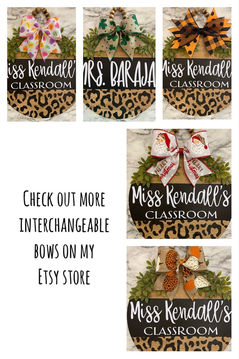 May include: Wooden classroom signs with interchangeable bows. The signs have a black top with white text and a leopard print bottom. The bows feature various designs, including hearts, shamrocks, and Santa Claus.