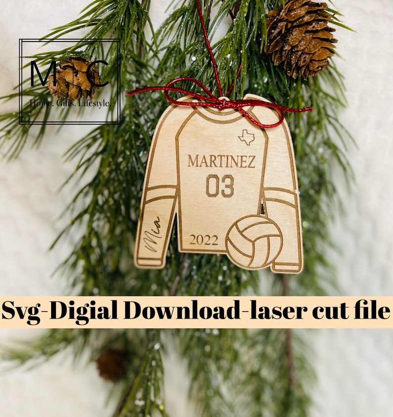 May include: A wooden ornament shaped like a volleyball jersey with the name "MARTINEZ" and number "03" on the front. The ornament also includes a volleyball, the state of Texas, and the year "2022".
