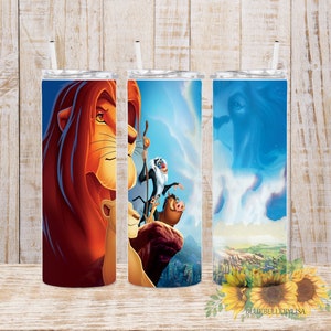 May include: Three stainless steel tumblers featuring images from the film The Lion King. The first tumbler shows a close-up of Simba's face. The second tumbler depicts Simba, Rafiki, and Pumbaa on Pride Rock. The third tumbler shows a scene from the film with a blue sky and clouds.
