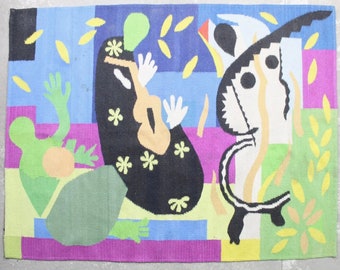 May include: A colorful abstract rug with a black, white, and yellow butterfly design, a green figure, and a black figure with yellow flowers. The rug is made of woven fabric and has a geometric pattern.