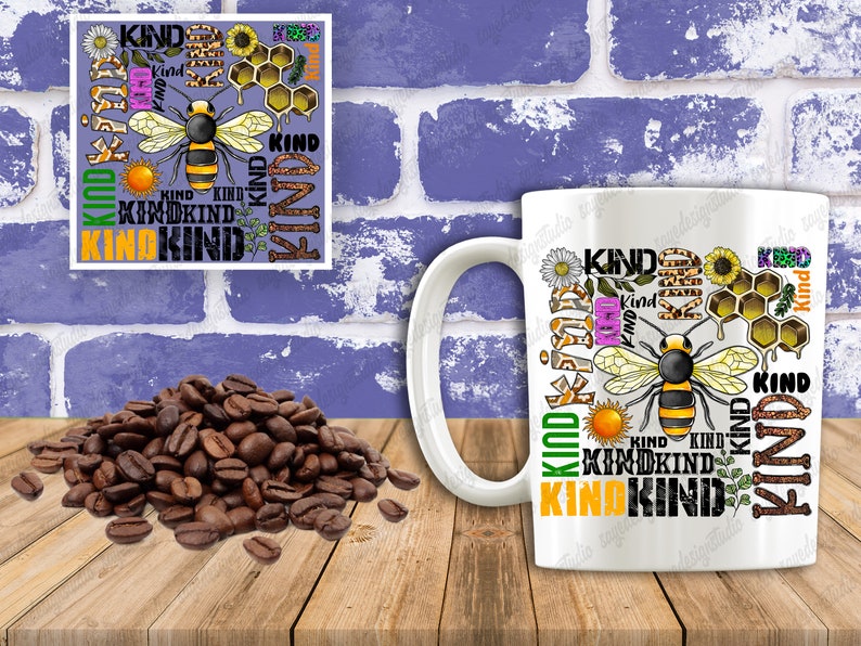 May include: White ceramic mug with a colorful design featuring a bee, honeycomb, flowers, and the word "KIND" repeated multiple times.