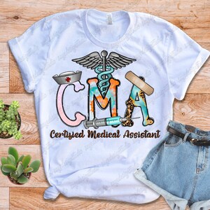 May include: White t-shirt with a colorful graphic design that says "CMA Certified Medical Assistant". The graphic includes a medical symbol, a bandage, a stethoscope, and a syringe.