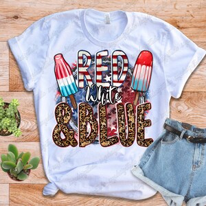 May include: White t-shirt with a red, white and blue graphic design featuring popsicles and the text "Red White & Blue" with a leopard print background.