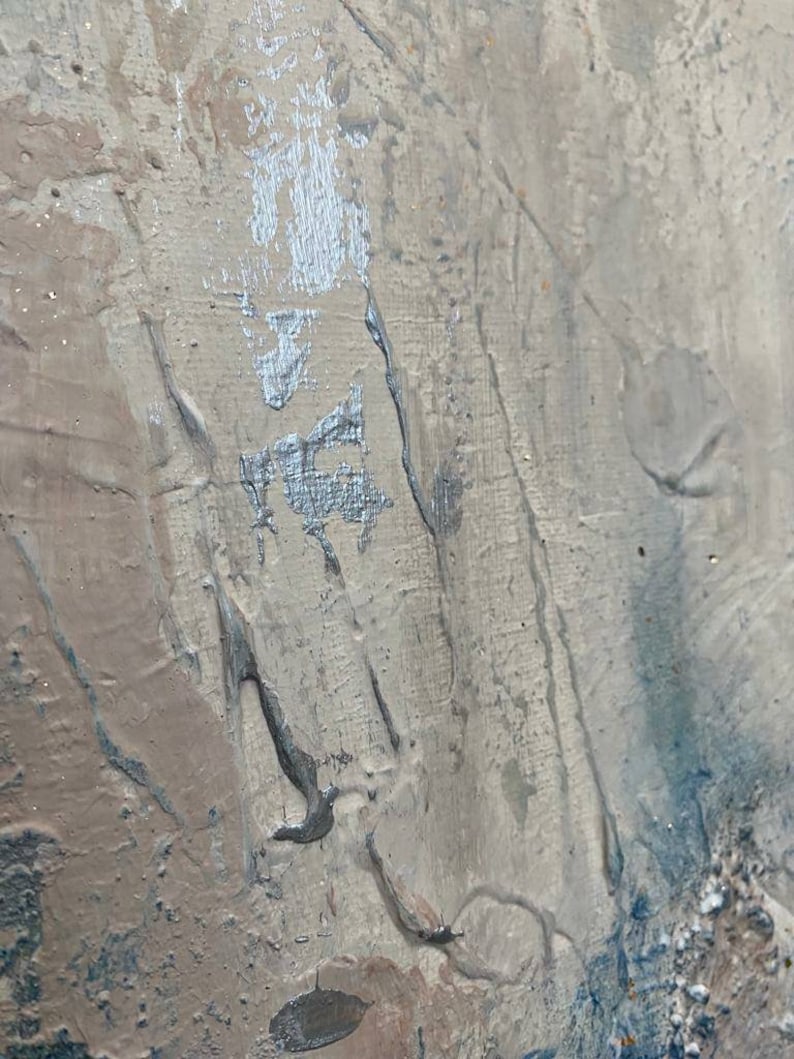 May include: Abstract painting with a textured, layered surface. The painting features shades of gray, brown, and blue, with a silver metallic accent.