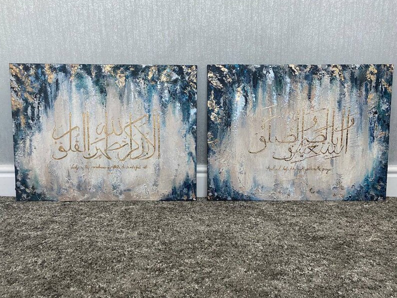 May include: Two abstract paintings with gold Arabic calligraphy on a blue and white background. The text on the left painting reads "Indeed, He is with the truthful." The text on the right painting reads "And He is with the patient."