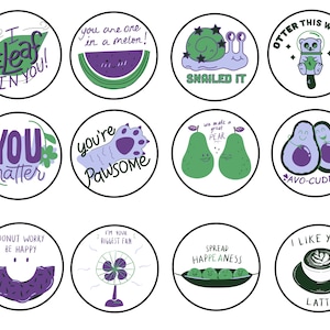 May include: Set of 12 round stickers with various illustrations and positive messages. The stickers feature a variety of colors, including purple, green, and white. The messages include "I beleaf in you!" "You matter" "You're Pawsome" "We make a great pear" "Avo-cuddle" "Donut worry be happy" "I'm your biggest fan" "Spread Happeaeness" "Otter this world" "Snailed it" "I like you a latte".