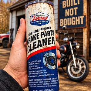 May include: A cylindrical tumbler with a metal straw, featuring a design that mimics a can of Lucas Oil Products Non-Chlorinated Brake Parts Cleaner. The white and blue label includes text, a brake disc graphic, and a net weight of 14 oz.