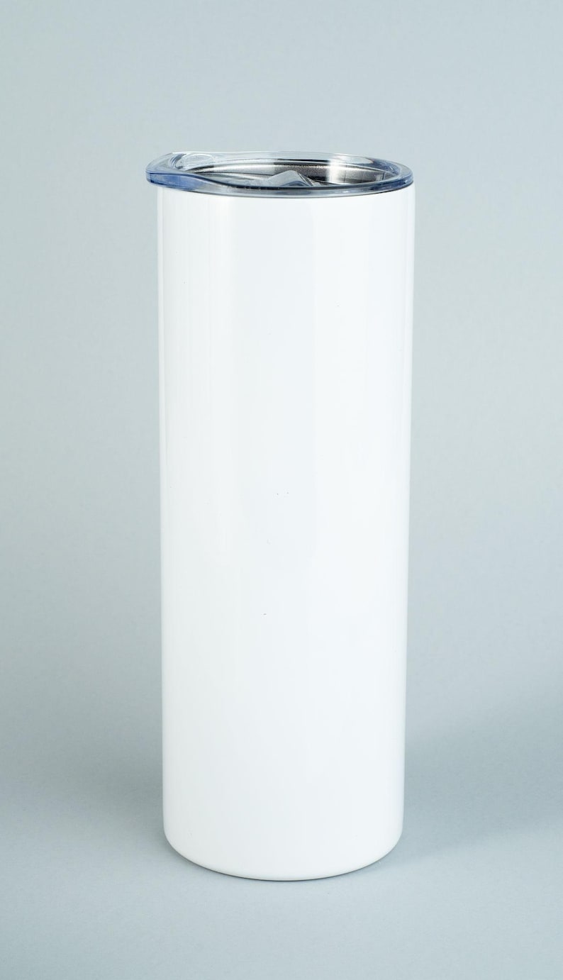 May include: A tall, cylindrical white tumbler with a smooth, glossy finish. The drinkware features a clear, transparent plastic lid that sits securely on top. The design is simple and vertical, providing a clean surface for customization or use.