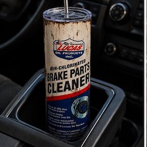 May include: A cylindrical tumbler with a clear lid and a metal straw, featuring a graphic design that mimics a Lucas Oil Products Non-Chlorinated Brake Parts Cleaner can. The design includes white, red, and blue colors with weathered, rusted textures.