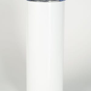 May include: A tall, cylindrical white tumbler with a smooth, solid finish. The container features a clear, removable plastic lid with a small opening and a matching white straw inserted through the top, providing a clean and simple design.