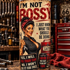 May include: A cylindrical metal tumbler with a straw featuring a vintage-style illustration of a mechanic, a red toolbox, and text that reads: I'M NOT BOSSY I JUST KNOW WHAT YOU SHOULD BE DOING, YES, I WILL FIX YOUR CAR NO, I WON'T DO IT FOR FREE.