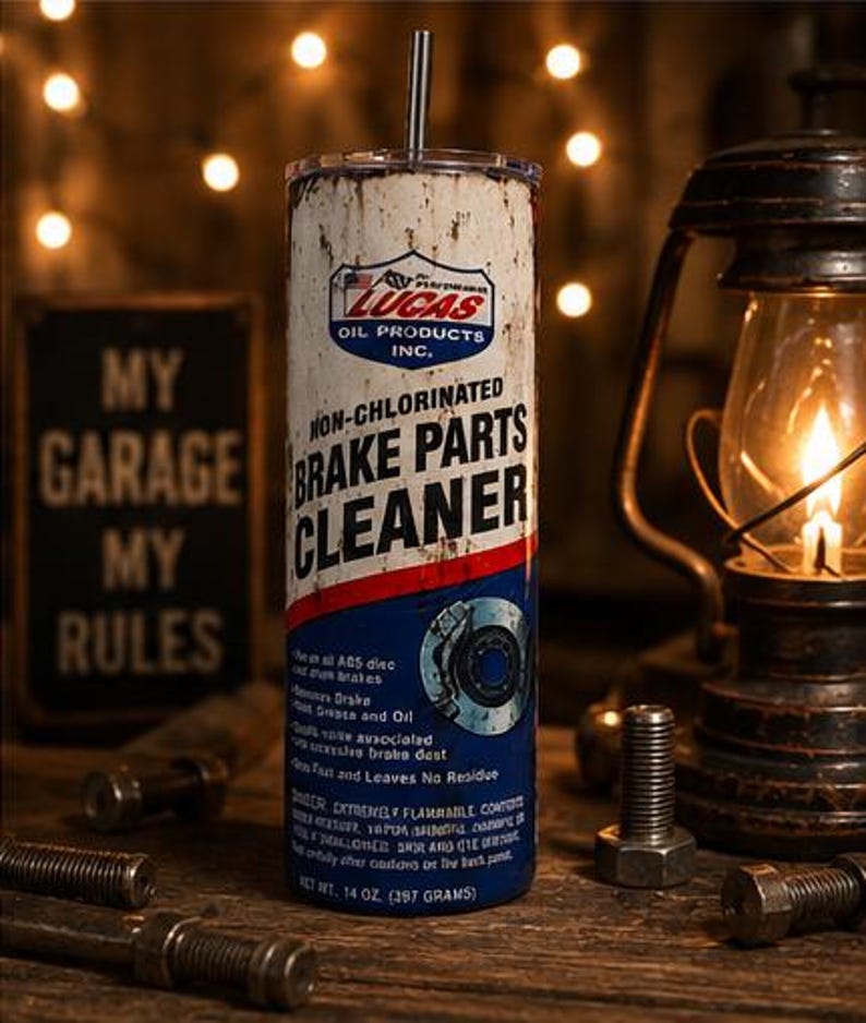 May include: A cylindrical tumbler featuring a distressed white, red, and blue graphic design mimicking a Lucas Oil Non-Chlorinated Brake Parts Cleaner can. The design includes the brand logo, text, a brake disc illustration, and a metal straw.