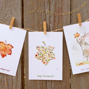 May include: Three Thanksgiving cards with watercolour illustrations. The first card features a single orange and red leaf. The second card features a cluster of leaves in the shape of a bell. The third card features a rabbit holding a leaf. All cards have the text "Happy Thanksgiving!"