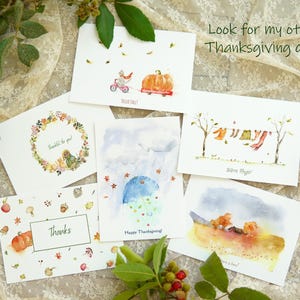 May include: Set of 6 watercolour Thanksgiving greeting cards featuring various autumnal scenes, including a pumpkin, a squirrel, a wreath, and a family of bears. The cards are printed on white cardstock and have a matte finish. The text on the cards includes "Thankful for you", "Happy Thanksgiving", "Warm Hugs", "Thanks", and "Look for my other Thanksgiving cards".