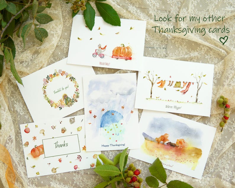 May include: Set of 6 watercolour Thanksgiving greeting cards featuring various autumnal scenes, including a pumpkin, a squirrel, a wreath, and a family of bears. The cards are printed on white cardstock and have a matte finish. The text on the cards includes "Thankful for you", "Happy Thanksgiving", "Warm Hugs", "Thanks", and "Look for my other Thanksgiving cards".