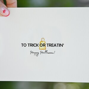 May include: A white card with the text "To Trick or Treatin' Happy Halloween!" and a watercolor illustration of a brown paper bag.