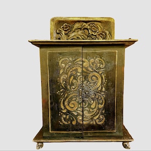 front view of cabinet * Note doors have plaster relief  with hand carved top piece.