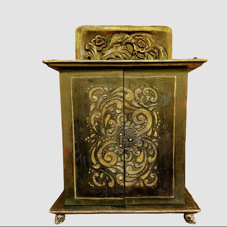 front view of cabinet * Note doors have plaster relief  with hand carved top piece.