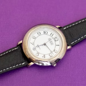 8 inch, Vintage Black Strap Silver Tone Watch by Bill Blass - Q30