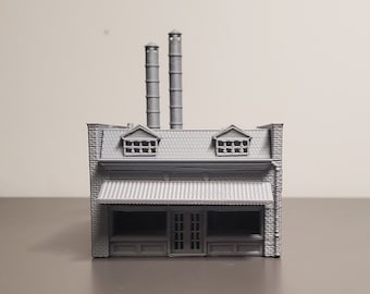 May include: A gray 3D printed model of a small building with two chimneys, a storefront, and two windows on the second floor.