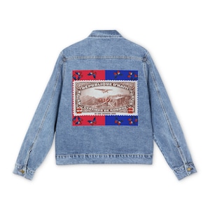 May include: A blue denim jacket with a red, white, and blue postage stamp design on the back. The stamp features an airplane and the text "Republique d'Haiti" and "50 Centimes de Gourde".