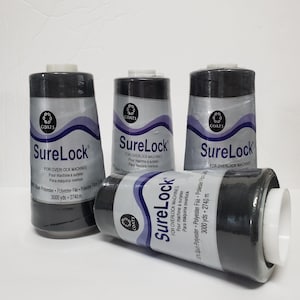 May include: Four spools of black SureLock thread for overlock machines. Each spool has a white top and a label with the brand name, product details, and the text "3000 yds - 2740 m".