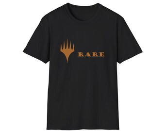 May include: Black t-shirt with a brown graphic and the word "RARE". The graphic is a stylized emblem with a crown-like design. The shirt is made of a soft material and has short sleeves.