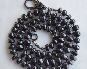 23" Black Spinel Smooth Rondelle Gemstones Hand Knotted On Black Silk. Black CZ Lobster Clasp Can Be Worn in Back or Front With Charms