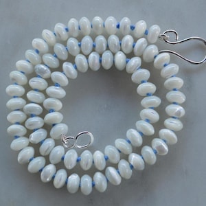 Shimmery Mother of Pearl 8mm Rondelle Necklace Hand Knotted on Sky Blue Silk.  Hand Forged Sterling Hook and Eye Clasp