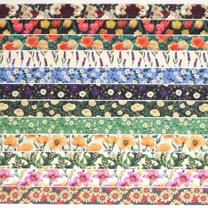 May include: A collection of floral patterned ribbons in various designs. The ribbons feature roses, tulips, lavender, and other flowers in shades of red, orange, yellow, purple, and green. The ribbons are arranged horizontally, showcasing the diverse floral patterns.