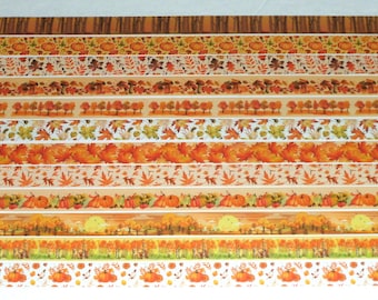 May include: A set of 12 washi tapes featuring autumnal designs. The tapes feature various fall colors, including orange, brown, yellow, and red. The designs include leaves, pumpkins, trees, and mushrooms.