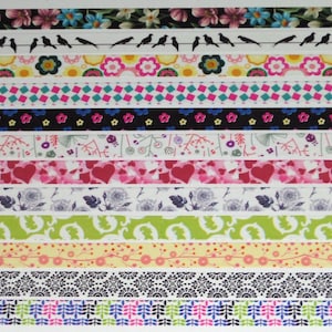 May include: A collection of decorative washi tapes with various patterns. Designs include floral, bird silhouettes on a wire, geometric shapes, hearts, and botanical motifs. The tapes feature a range of colors, including pink, blue, green, and black.